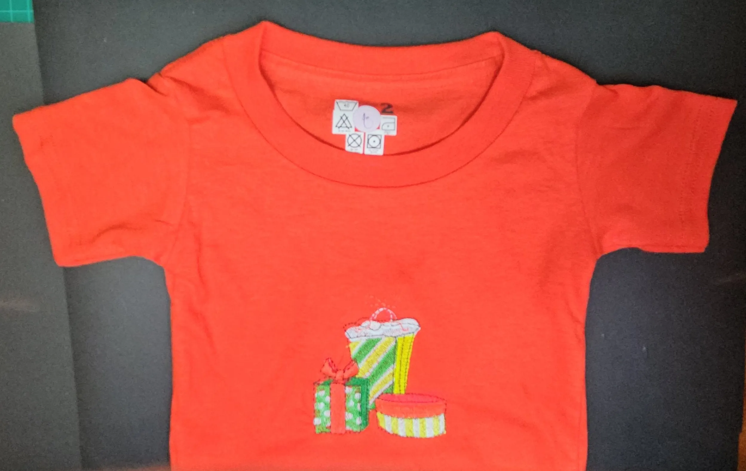 Christmas Presents embroidered, and Trendy Embroidered Sides on Red T-Shirts for Toddlers. Comfortable, soft Tees.